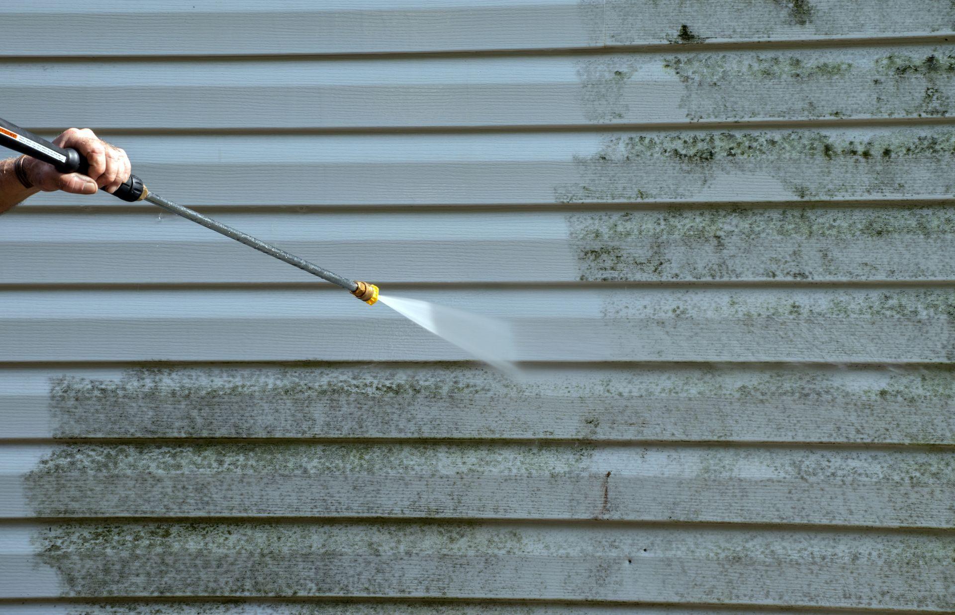 Hot water pressure washing a car wash facility