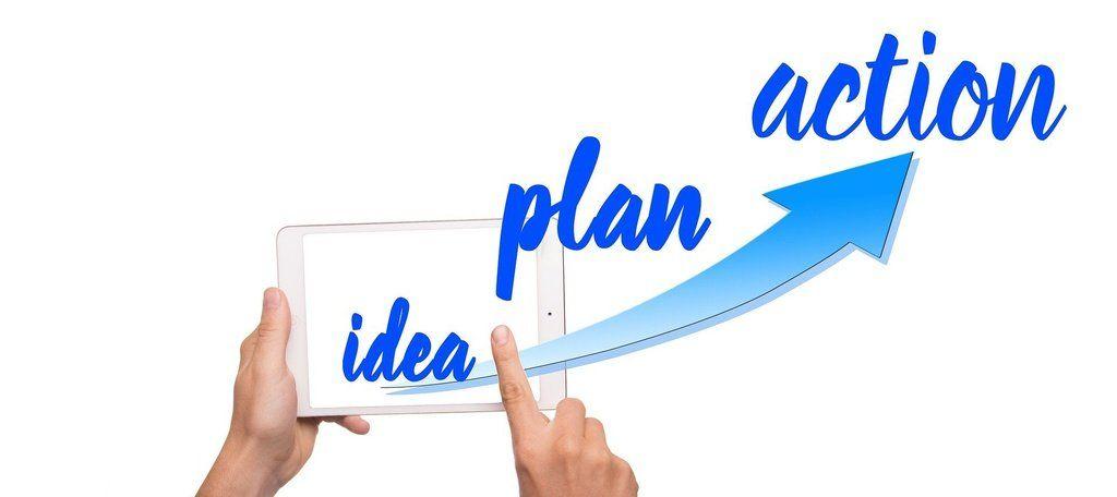Hands holding a tablet displaying idea, plan, action